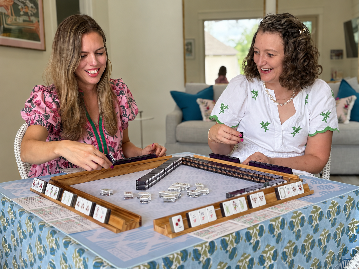 Megan and Martine laughing while playing American Mahjong